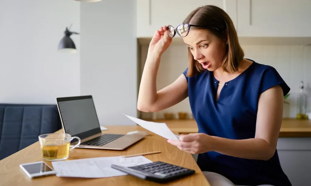 Home buying with closing cost estimate showing buyers reviewing mortgage documents, calculating settlement expenses, comparing lender fees, and preparing for a successful home purchase.